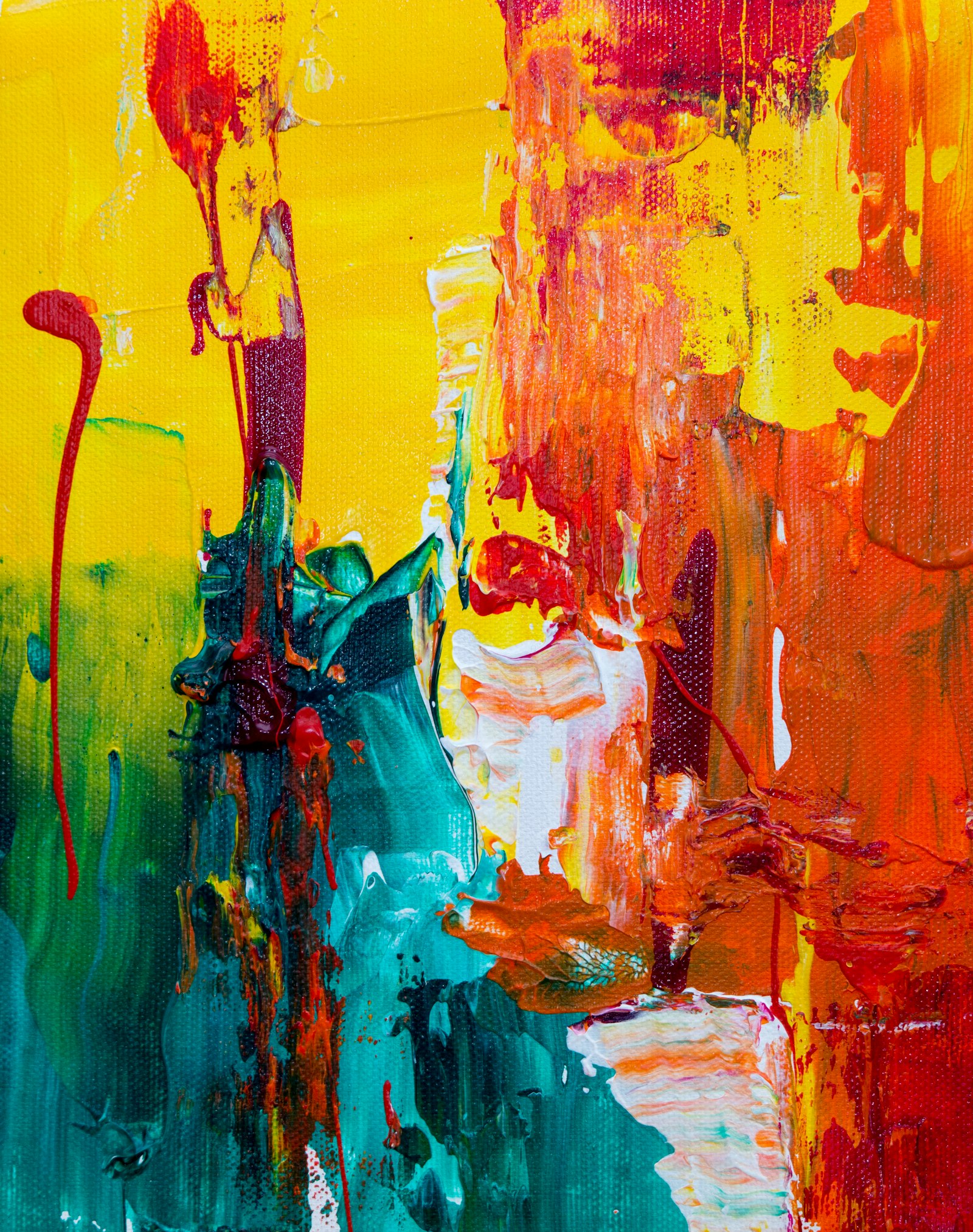 Abstract acrylic painting in thick strokes of yellow, teal, orange and deep red