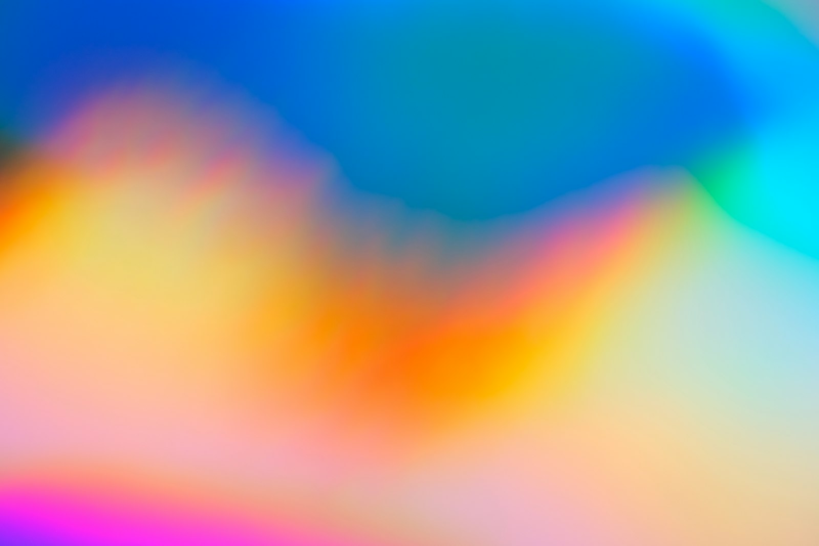 Soft colour-field gradient drifting from deep blue and teal into peach and pink