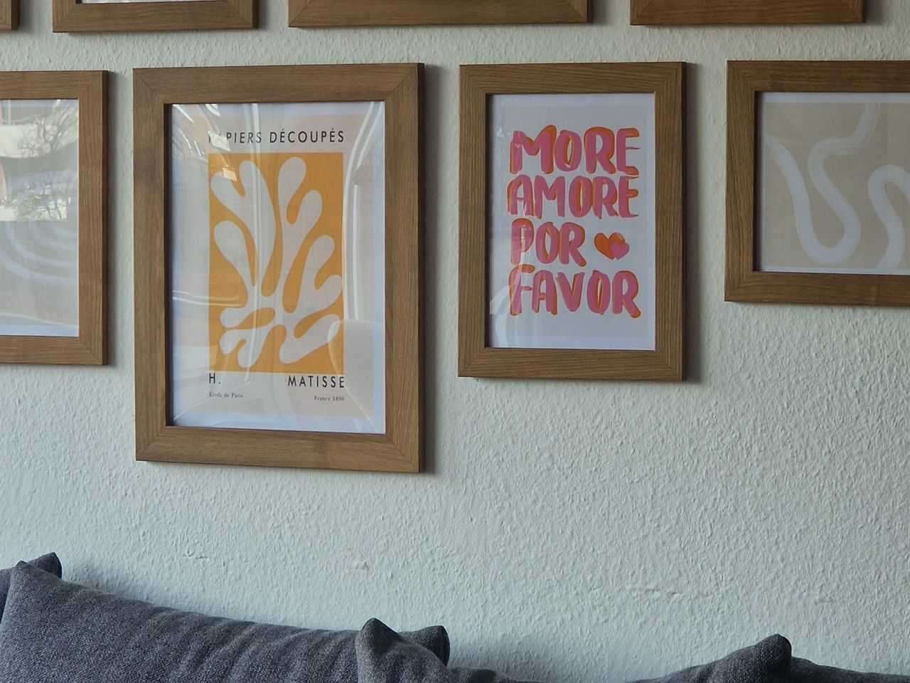 A colourful wall of posters and prints arranged edge to edge